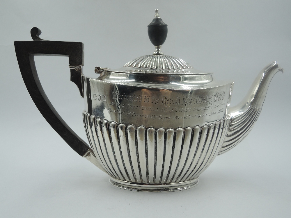 A Victorian silver teapot of oval form having gadrooned decoration to body with inscription to