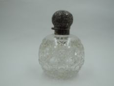 A Victorian cut glass scent bottle of spherical form having glass stopper and moulded silver lid,