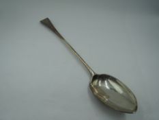 A Georgian silver basting spoon of Old English form bearing monogram to terminal, London 1793,