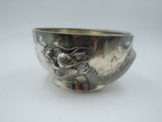 A Chinese silver Dragon bowl having Dragon Repousse decoration coiled round the bowl with pedestal