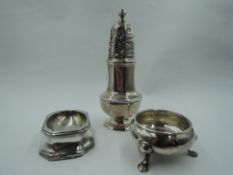 A Georgian silver sugar caster of waisted octagonal form having push on pierced lid. London 1806,