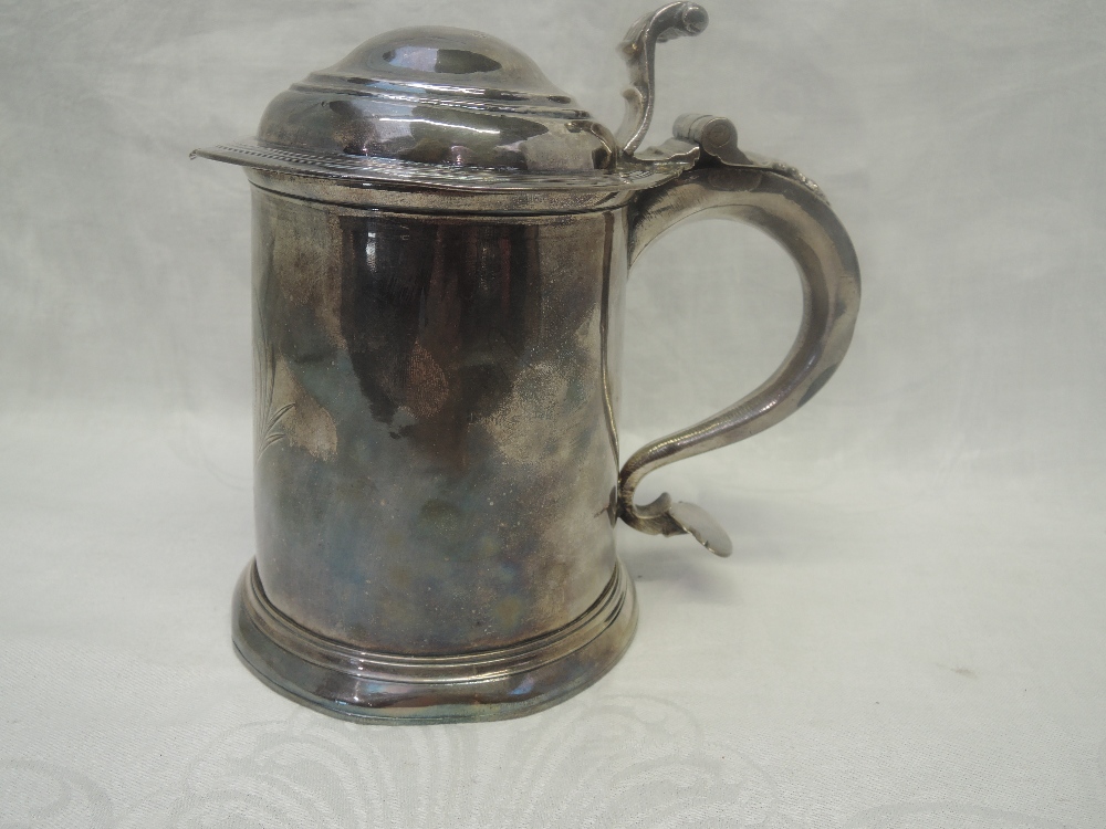 A Queen Anne Britannia standard silver tankard having cylindrical body and domed cover with scroll