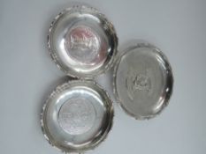 Three Chinese silver trinket dishes, two bearing British Trade dollar coins to base and other