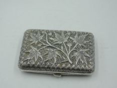 A white metal cigarette case having extensive repousse foliate decoration, no marks tests as silver