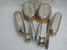 Four silver backed brushes and matching comb, all of plain form bearing monogram N to back, London
