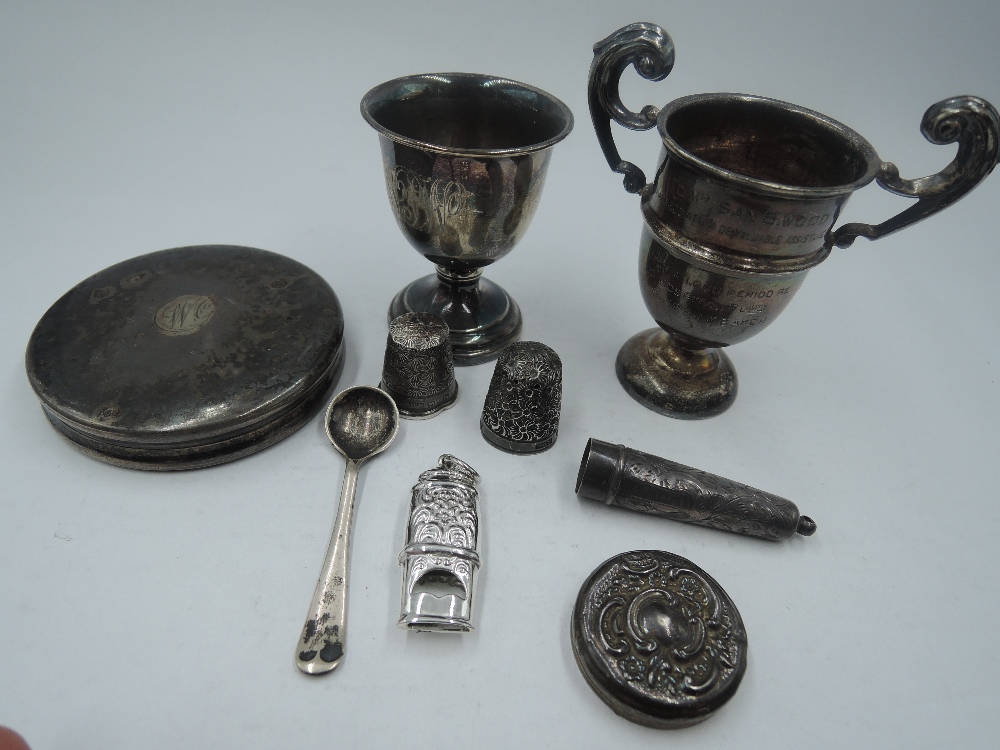 A small selection of HM silver and white metal including egg cup, trinket lid, miniature trophy cup,