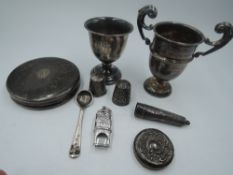 A small selection of HM silver and white metal including egg cup, trinket lid, miniature trophy cup,