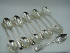 Nine Victorian silver dessert spoons in the fiddle and thread pattern, bearing Boar's head crest