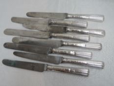 Eight Georgian silver table knives having moulded handles with engraved crests, London 1835,