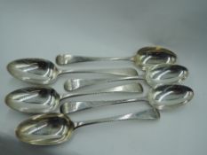 Six Georgian silver table spoons of Old English form bearing Ornithological crest to terminals,