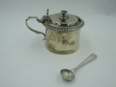 A Victorian silver mustard pot of plain cylindrical form having gadrooned rim and scallop shell