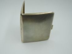 A 1930's silver cigarette case of slim form having engine turned decoration and bearing dated