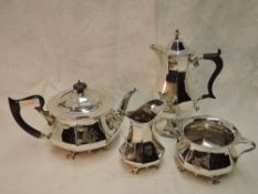 An Edwardian Art Nouveau three piece silver tea set of slender tapering panelled form, having