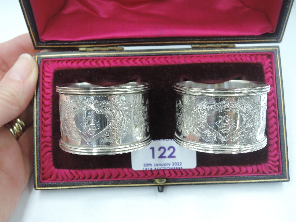A cased pair of Edwardian silver napkin rings having brightcut decoration and monogrammed - Image 2 of 3