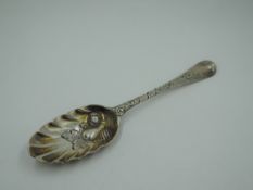 A Georgian silver berry spoon having gilt wash to fluted bowl with berry decoration, moulded