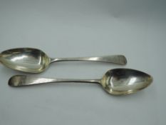 Two Georgian silver table spoons of Old English form bearing a galleon to one terminal and castle