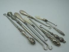 Seven HM silver and white metal button hooks of various forms and two similar having Mother of pearl