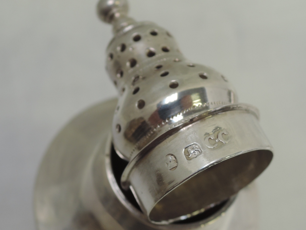 A matched pair of Georgian silver pepper casters of urn form with pierced push on lids and square - Image 3 of 4