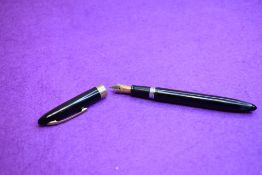 A Sheaffer Thin Model Autograph plunger fill fountain pen in black with gold clip and single band to