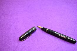 A Mabie Todd & Co Swan 6261 Self Filler Leverfill, in black with two bands to the cap and a Swan No2