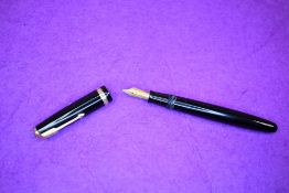 A Parker Duofold button fill fountain pen in black with a single broad decorated band to cap