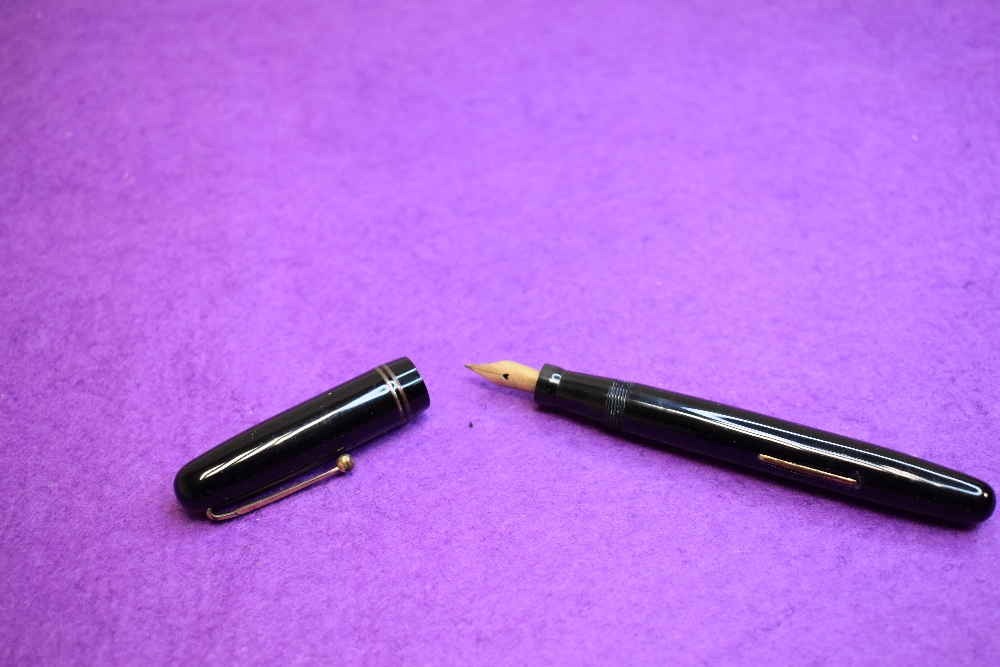 A Mabie Todd & Co Swan 3260 Self Filler Leverfill, in black with two bands to the cap and a Swan No2