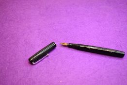 A Mabie Todd Swan Self-filler leverfill fountain pen in black with chaising having a Swan 1 nib.