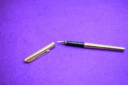 A Parker 180 plunger fill fountain pen in gold. Approx 13.3cm