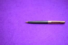 A Parker propelling pencil in grey with gold cap