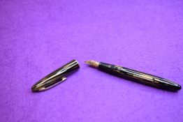 A Sheaffer balance Lifetime lever fill fountain pen in brown striated with single narrow rim to