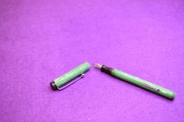 A Platignum leverfill fountain pen in green and cream with threaded base to barrel to hold cap