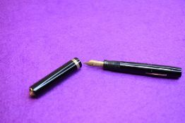 A Sheaffer flat top fountain pen in black with single band to ring top having Sheaffer Lifetime nib.