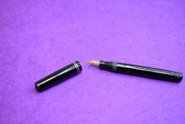 A Mabie Todd & Co Swan L112/60 Leverless twist filler, in black with two bands to clipless cap and a