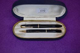 A Parker Slimfold fountain pen and propelling pencil set in black with narrow decorated band to cap,