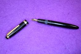 A Montblanc 202 button fill fountain pen in black with gold trim having Montblanc 2 nib. Approx 12.