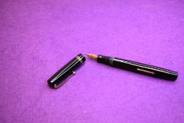 A Mabie Todd & Co Swan 6260 Self Filler Leverfill, in black with two bands to the cap and a Swan No2