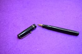 A Mabie Todd & Co Swan Leverless twist filler, in black with two bands to cap (cap missing screw