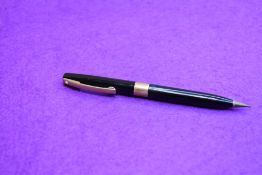 A Sheaffer propelling pencil in black with broad band and gold clip