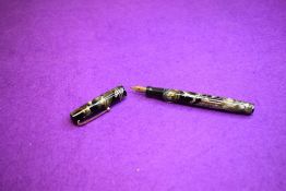 A Mabie Todd Swan Self-filler leverfill fountain pen in grey marble with two narrow bands to cap