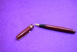 A Mabie Todd & Co Swan Leverless twist filler, in maroon with two narrow and one broad band to cap