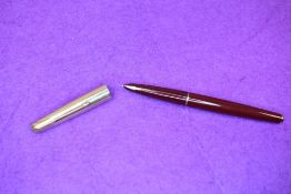 A Parker 61 fountain pen in red with rolled gold cap (worn with small dent). Approx 13.4cm