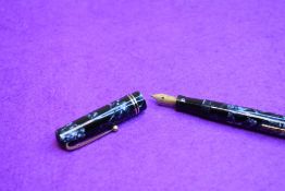 A Mabie Todd Swan Self-filler Leverfill fountain pen in blue marble with 2 gold bands to the cap