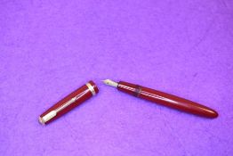 A Parker Duofold fountain pen in red with broad decorative band to cap having a Parker 585 10 nib.