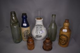 A selection of vintage advertising bottles including Buckleys and DR Nelson