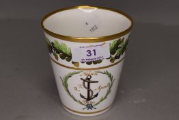 A porcelain beaker or cup being hand decorated marked Nelson 2nd April Baltic