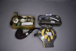 A selection of curios including smokers pipe, gentlemans wristwatch and pocket knives