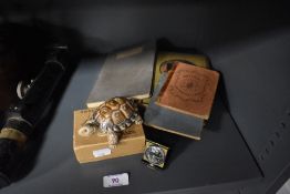 A selection of reference books, a boxed Wade turtle and a Swiss travel watch