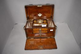 A late Victorian portable tea caddy having fitted compartments and storage drawers with spirit in