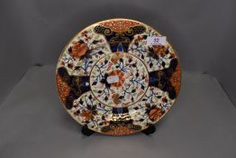 An antique hand decorated Imari design plate by Royal Crown Derby having an early painted back