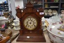 A vintage style bracket wall clock with mahogany styled case